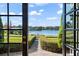 Open french doors showcase a breathtaking lake view from inside the home at 1522 Lake Knowles Cir, Winter Park, FL 32789