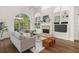 Living room with hardwood floors, fireplace, built-in shelving at 1522 Lake Knowles Cir, Winter Park, FL 32789