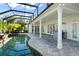 Spacious covered patio overlooking a refreshing pool and spa at 1522 Lake Knowles Cir, Winter Park, FL 32789