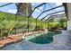 Relaxing screened-in pool and spa with stone waterfall feature at 1522 Lake Knowles Cir, Winter Park, FL 32789