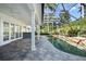 Covered patio with pool and spa, surrounded by lush landscaping at 1522 Lake Knowles Cir, Winter Park, FL 32789