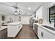 Open concept kitchen with white cabinets and quartz countertops at 1523 N Beach St, Ormond Beach, FL 32174