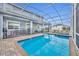 Inviting screened pool with spa and patio at 1533 Maidstone Ct, Champions Gate, FL 33896