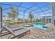 Screened pool and spa with lounge chairs at 1533 Maidstone Ct, Champions Gate, FL 33896