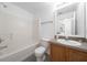 Clean bathroom with a tub, toilet, and wood vanity at 1613 Lansfield Ave, Deltona, FL 32738