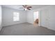 Bedroom with ceiling fan, carpet flooring, wainscoting, and en-suite bathroom at 1613 Lansfield Ave, Deltona, FL 32738