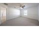 Bedroom with ceiling fan, carpet flooring, and wainscoting at 1613 Lansfield Ave, Deltona, FL 32738