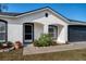 Front entrance of a charming house with landscaping and a walkway at 1613 Lansfield Ave, Deltona, FL 32738