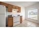 Bright kitchen with oak cabinets, granite countertops, and a window view at 1613 Lansfield Ave, Deltona, FL 32738