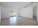 Bright and airy living room with tile floors and sliding glass doors at 1613 Lansfield Ave, Deltona, FL 32738