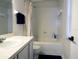 Clean bathroom with a shower/tub combo and white tile at 1621 Slash Pine Pl, Oviedo, FL 32765