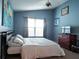 Serene bedroom with a king-size bed and calming blue walls at 1621 Slash Pine Pl, Oviedo, FL 32765