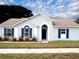 One-story house with blue shutters and a landscaped lawn at 1621 Slash Pine Pl, Oviedo, FL 32765