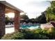 Community pool with brick pavilion and lounge chairs at 1621 Slash Pine Pl, Oviedo, FL 32765