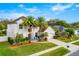 Two-story house with white exterior, palm trees, and landscaped yard at 1706 Tiverton St, Winter Springs, FL 32708