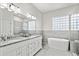 Bathroom with double vanity, soaking tub, and glass shower at 1706 Tiverton St, Winter Springs, FL 32708