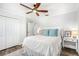 Bright bedroom with a queen bed, double doors, and wood floors at 1706 Tiverton St, Winter Springs, FL 32708