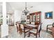 Formal dining room with wood table and chandelier, hardwood floors at 1706 Tiverton St, Winter Springs, FL 32708