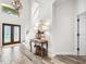 Bright entryway with wood-look tile floors, console table, and double doors at 1706 Tiverton St, Winter Springs, FL 32708