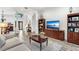 Living room with hardwood floors, sectional sofa, built-in shelving and fireplace at 1706 Tiverton St, Winter Springs, FL 32708