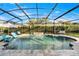 Inviting pool area with screened enclosure, lounge chairs, and a waterfall feature at 1706 Tiverton St, Winter Springs, FL 32708