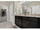 Bathroom with double vanity, granite countertops, and dark cabinets at 1720 Columbus Path, St Cloud, FL 34771