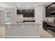 Modern kitchen island with granite countertops and dark cabinetry at 1720 Columbus Path, St Cloud, FL 34771