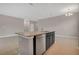 Kitchen island with granite countertop and stainless steel dishwasher at 1720 Columbus Path, St Cloud, FL 34771