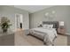 Main bedroom with a striped comforter, and neutral wall color at 1720 Columbus Path, St Cloud, FL 34771