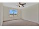 Bedroom with carpet flooring, ceiling fan and window with a view at 1794 Hackberry St, Clermont, FL 34715