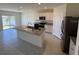 Modern kitchen featuring granite countertops and stainless steel appliances at 1794 Hackberry St, Clermont, FL 34715