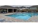 Community pool with lounge chairs and covered seating area at 1794 Hackberry St, Clermont, FL 34715