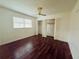 Bedroom with hardwood floors and mirrored closet doors at 1854 Sepalwood Ct, Orlando, FL 32818