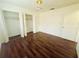 Bedroom with hardwood floors and mirrored closet doors at 1854 Sepalwood Ct, Orlando, FL 32818