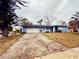 Front view of a light blue house with a white garage door at 1854 Sepalwood Ct, Orlando, FL 32818