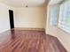 Bright living room with wood-look floors and large windows at 1854 Sepalwood Ct, Orlando, FL 32818