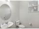 Small bathroom with oval mirror, toilet, and single sink vanity at 2041 Brillante Dr, St Cloud, FL 34771