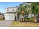 Two-story house with white exterior, landscaping, and palm trees at 2041 Brillante Dr, St Cloud, FL 34771