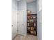 Hallway with tile flooring, bookshelf, and coat closet at 2041 Brillante Dr, St Cloud, FL 34771