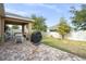 Large backyard with patio, grill, and grassy area at 2204 Napone Ln, Minneola, FL 34715