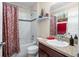 Clean bathroom with tub, shower, and updated vanity at 2204 Napone Ln, Minneola, FL 34715