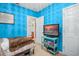 Bedroom with teal walls, TV, and ensuite bathroom access at 2204 Napone Ln, Minneola, FL 34715