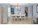 Bright dining room featuring a white table and six chairs at 2204 Napone Ln, Minneola, FL 34715