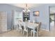 White dining table with six chairs in a bright dining area at 2204 Napone Ln, Minneola, FL 34715