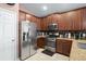 Kitchen with stainless steel appliances and wood cabinets at 2204 Napone Ln, Minneola, FL 34715