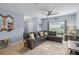 Living room with sectional sofa, decorative accents and large windows at 2204 Napone Ln, Minneola, FL 34715