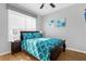 Bedroom with a teal comforter and private bathroom access at 2546 Renshaw St, Kissimmee, FL 34747