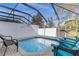 Screened-in pool area with patio furniture and a small pool at 2546 Renshaw St, Kissimmee, FL 34747