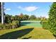 Well-maintained tennis court surrounded by greenery at 2546 Renshaw St, Kissimmee, FL 34747