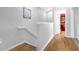 Upstairs hallway with wood floors and access to bedrooms at 2546 Renshaw St, Kissimmee, FL 34747